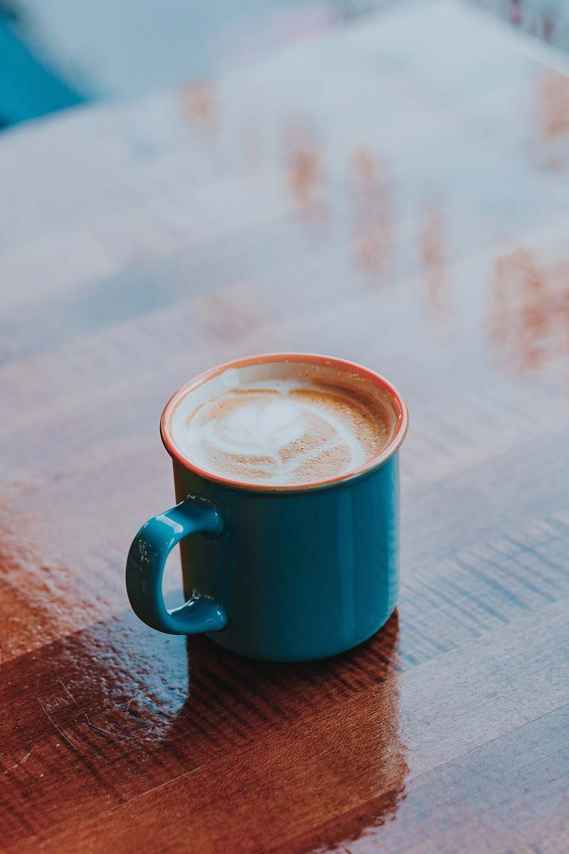 coffee cup selective focus photography of full blue mug cup